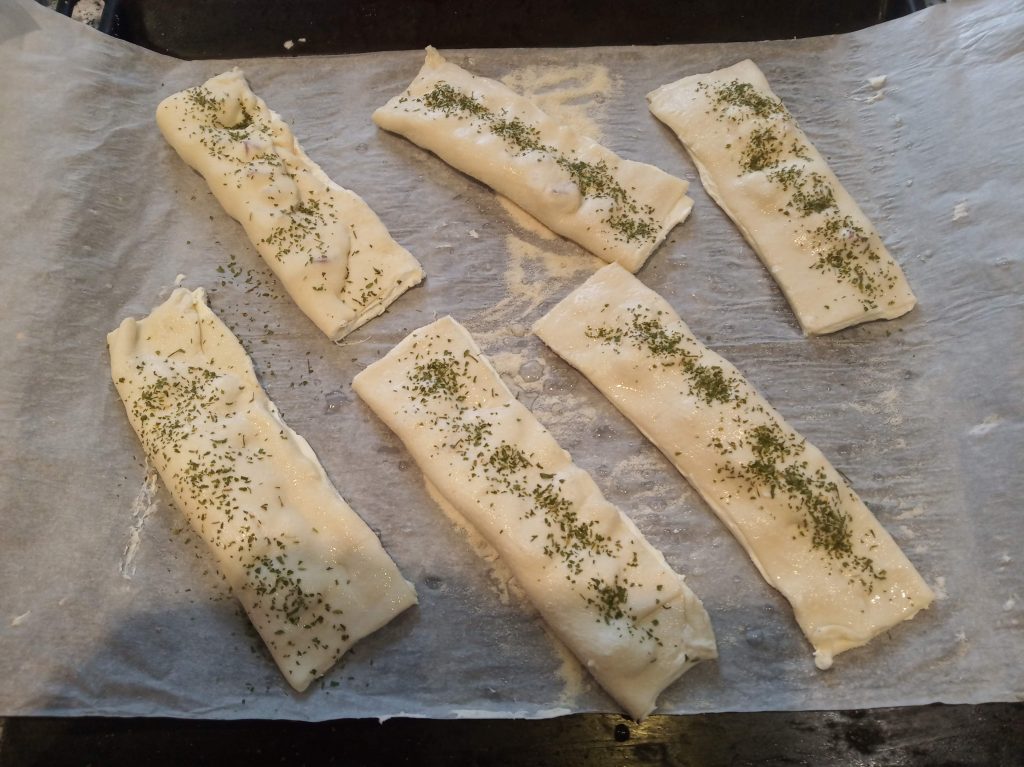 Triángulos de hojaldre con queso de untar y taquitos de jamón